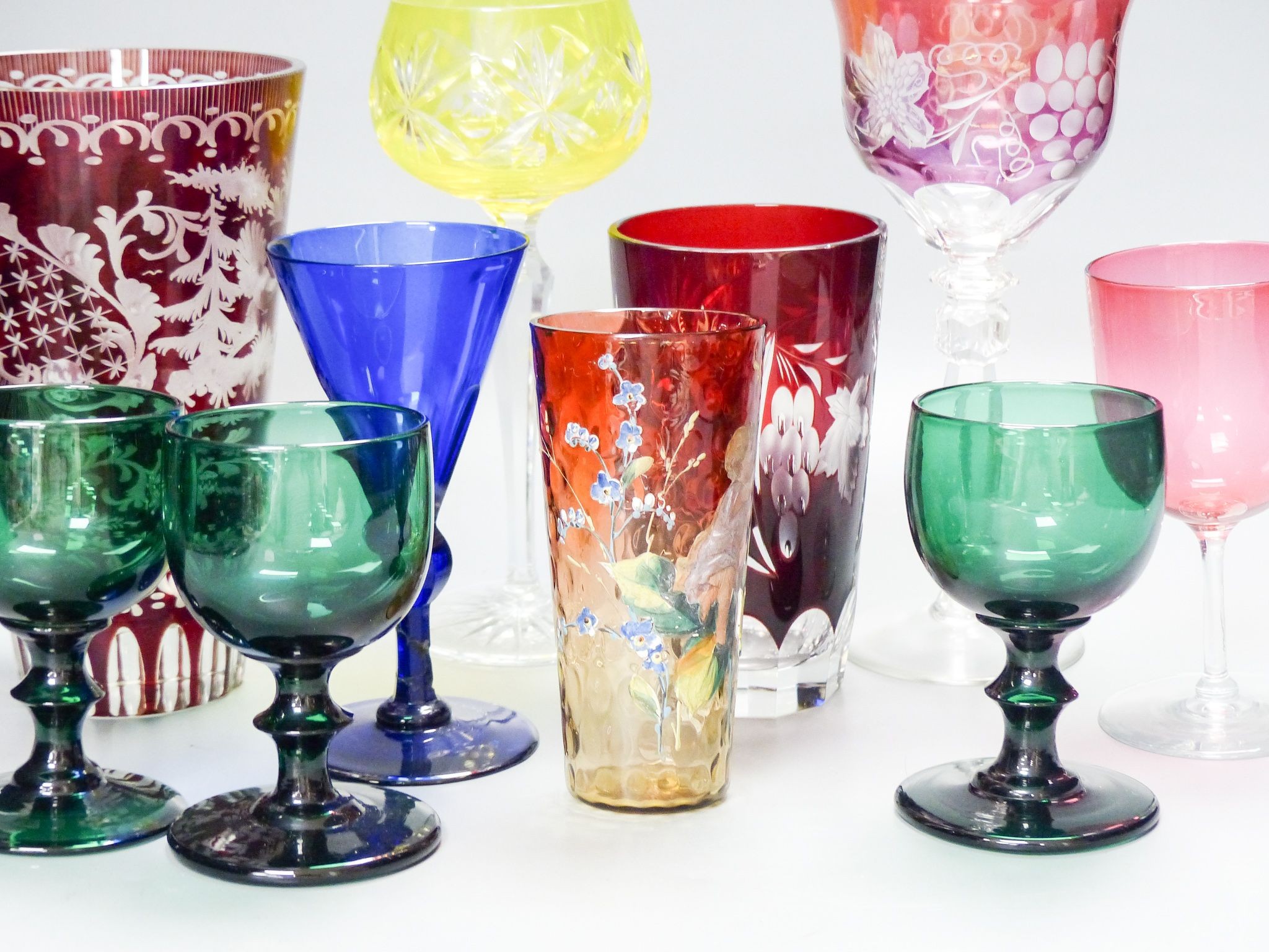 A collection of mixed 19th/20th century coloured drinking glasses, tallest 20cm